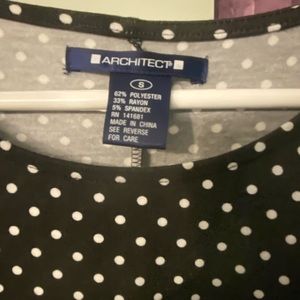 Above knee length black and white polka dot dress .